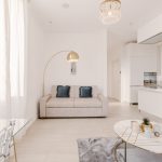 Bright and airy contemporary living room with minimalist design and white furnishings.