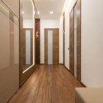 Sleek and luxurious hallway featuring wooden elements, elegant lighting, and modern design.