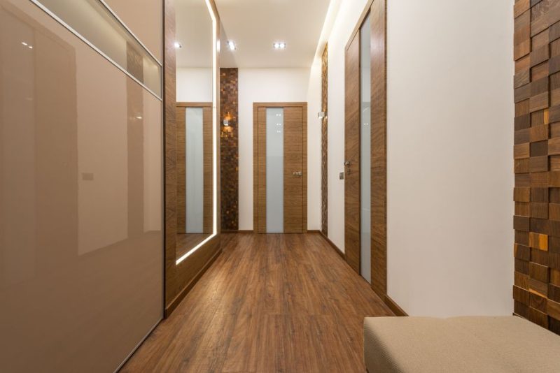 Sleek and luxurious hallway featuring wooden elements, elegant lighting, and modern design.